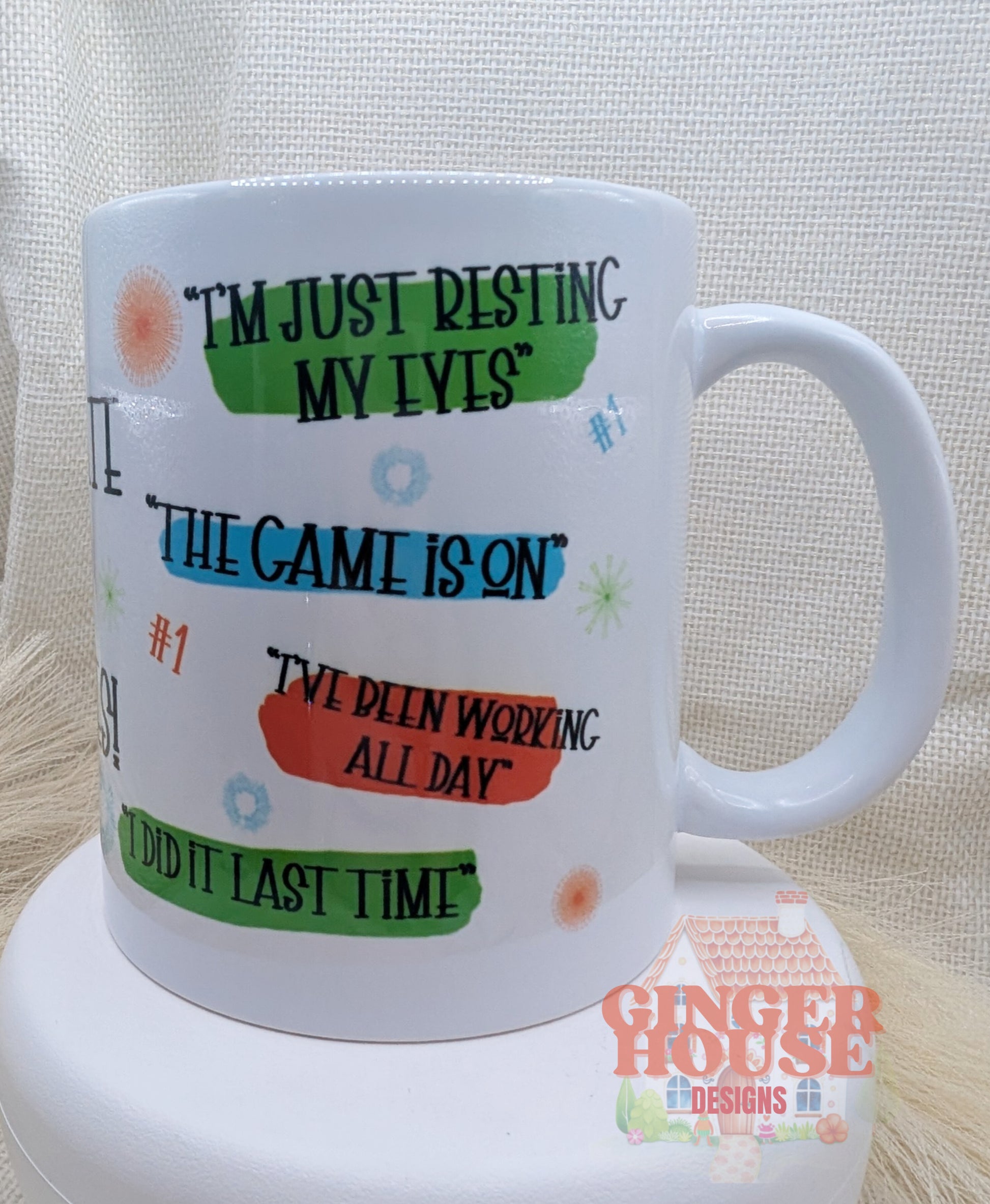 White mug with colorful text phrases on a white background